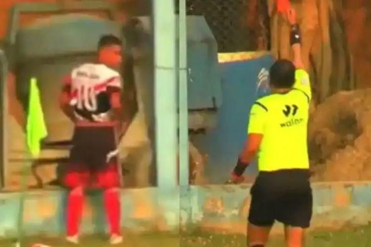 A footballer urinates on the field; the referee gives him marching orders